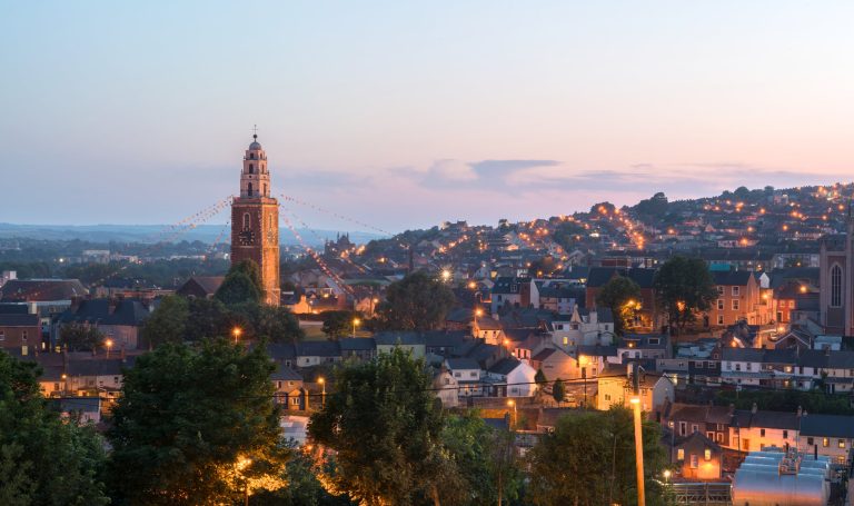 Cork, Ireland - July 19, 2013: St. Anne's in Shandon and the City of Cork photographed against a beautiful sunset at dusk.
