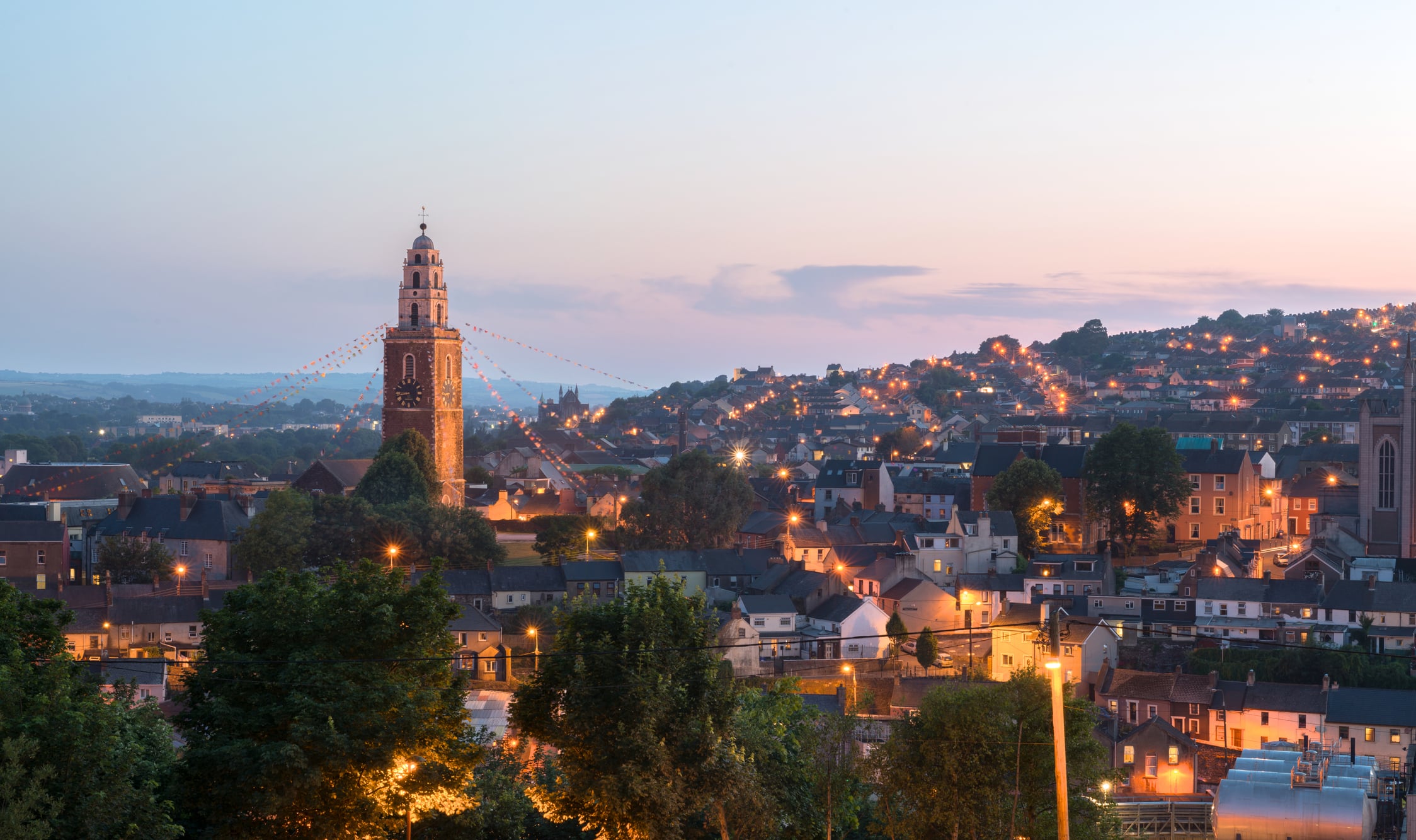 Cork, Ireland - July 19, 2013: St. Anne's in Shandon and the City of Cork photographed against a beautiful sunset at dusk.