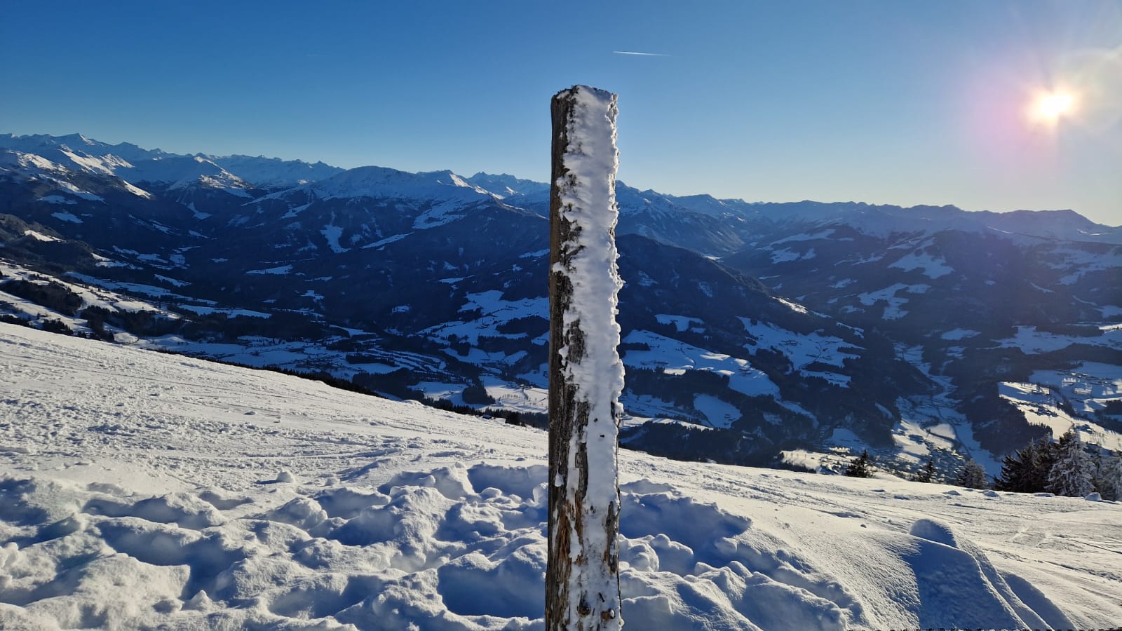A wooden pole in the snow